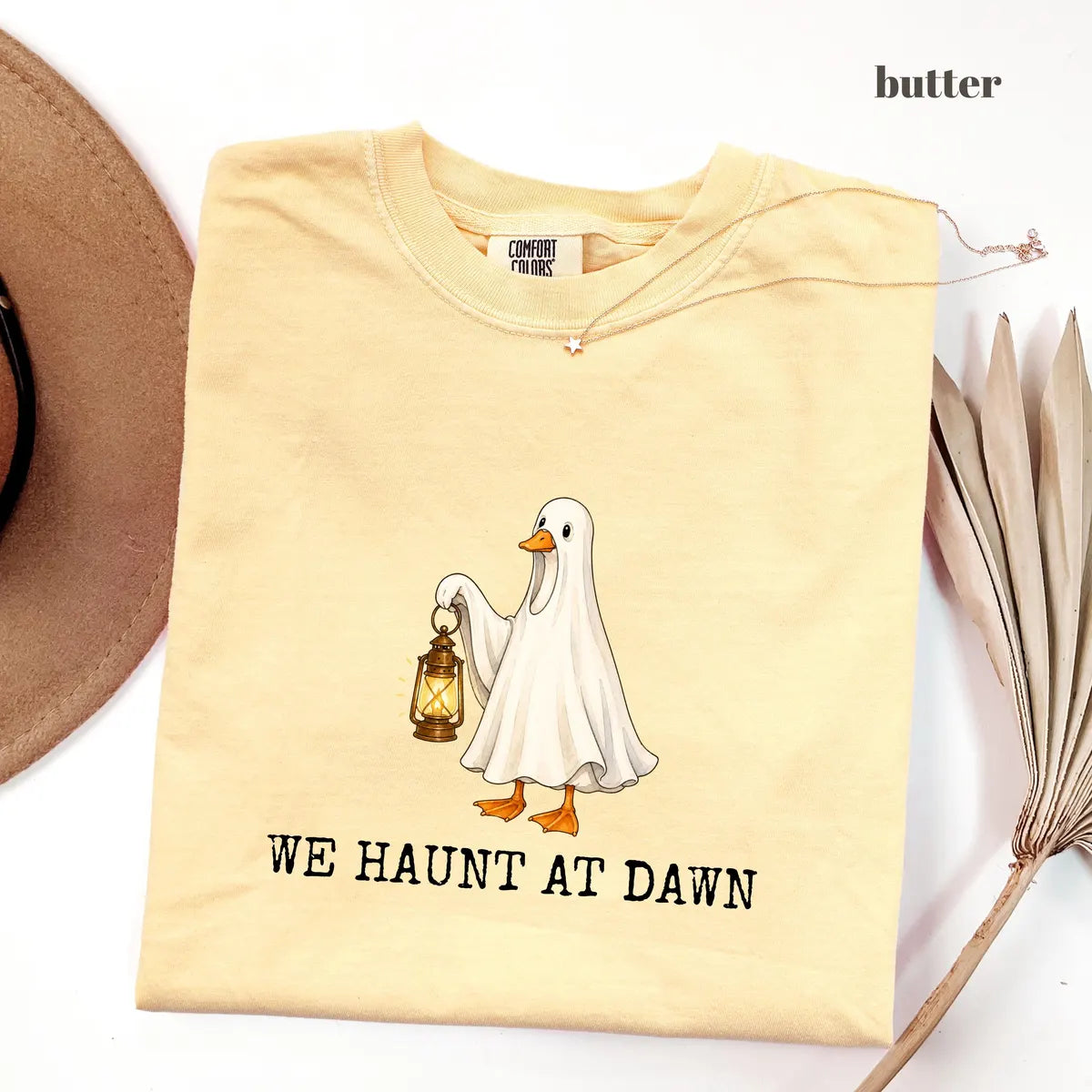 Butter Comfort Colors 1717 T-shirt with We Haunt At Dawn Goose design worn by a model