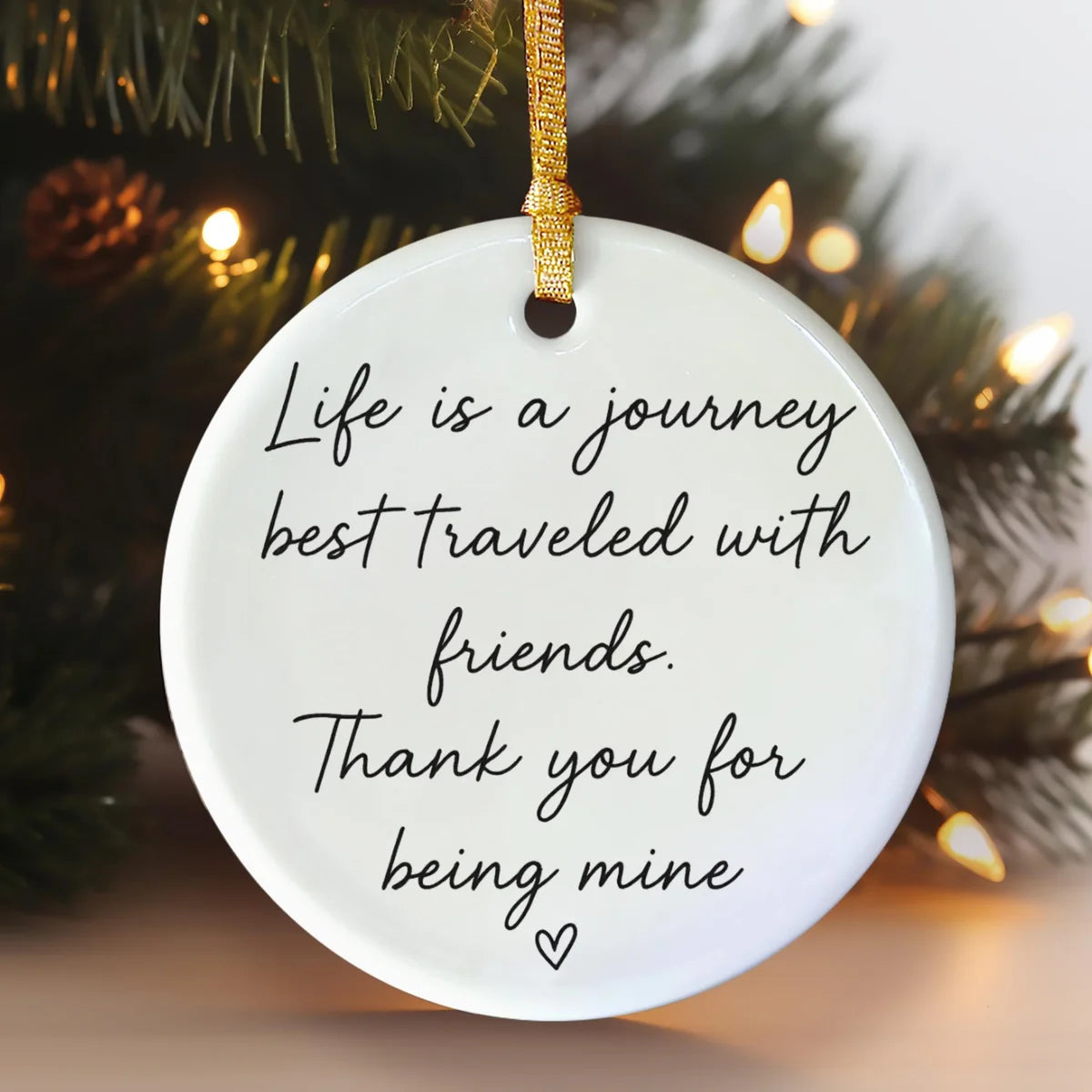 Alternate view of a round ceramic ornament with the visible Life Is a Journey Best Traveled With Friends message.