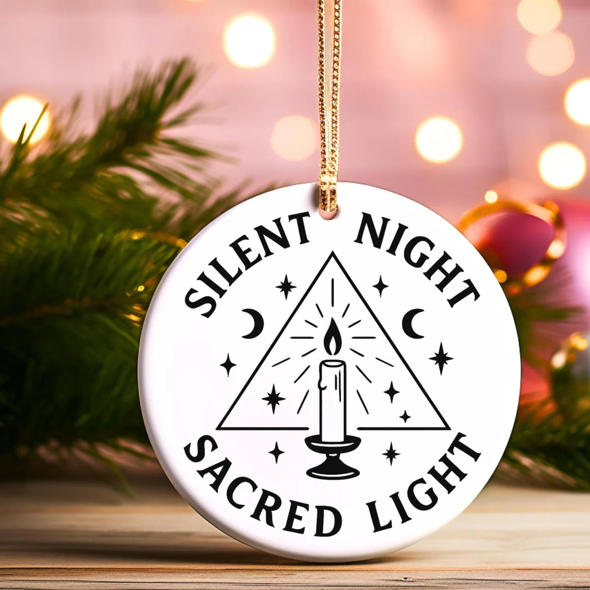 Alternate view of a round ceramic ornament with the visible Silent Night Sacred Light message.