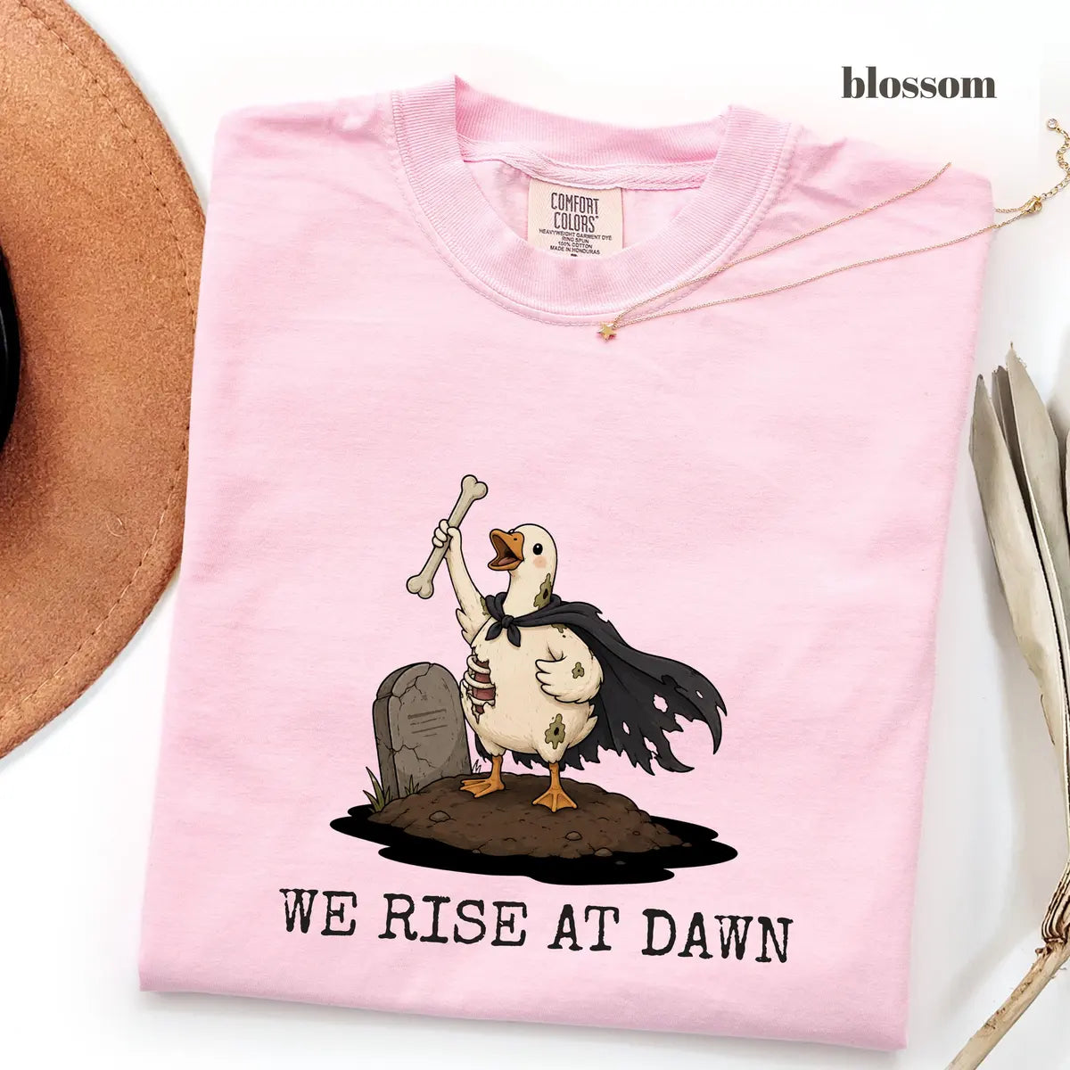 Blossom Comfort Colors 1717 T-shirt with We Rise at Dawn Halloween design worn by a model