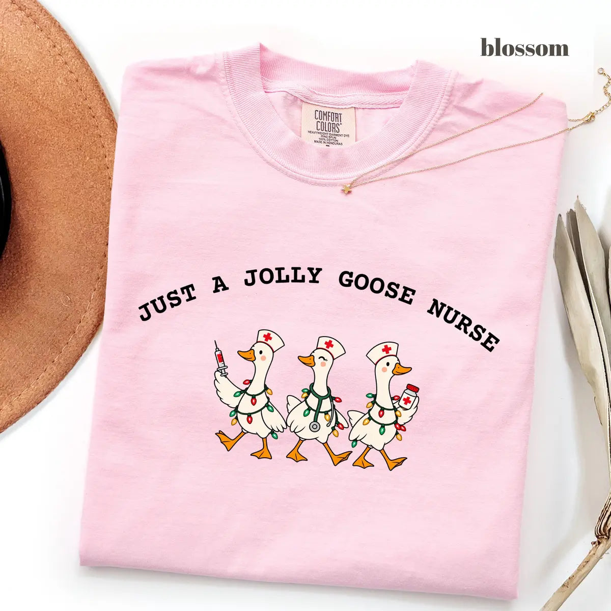 Blossom Comfort Colors 1717 T-shirt with Jolly Goose Christmas Nurse design worn by a model