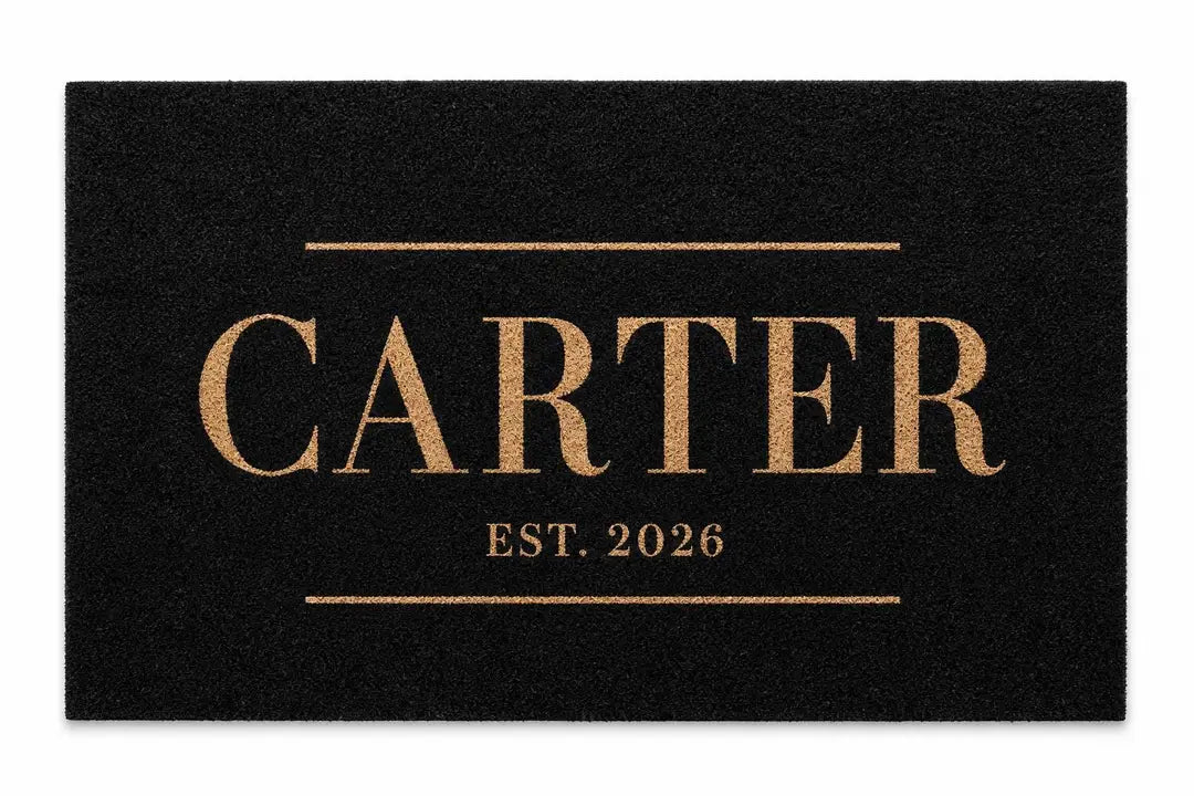 Flat view of a black doormat with a gold Carter name between two lines