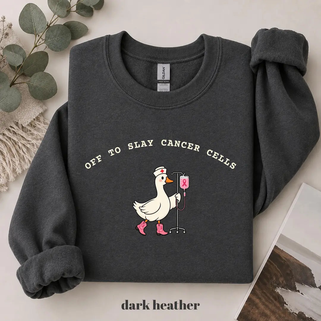 Dark Heather crewneck sweatshirt with printed a nurse goose in pink boots with an IV pole and the words off to slay cancer cells, flat lay view.