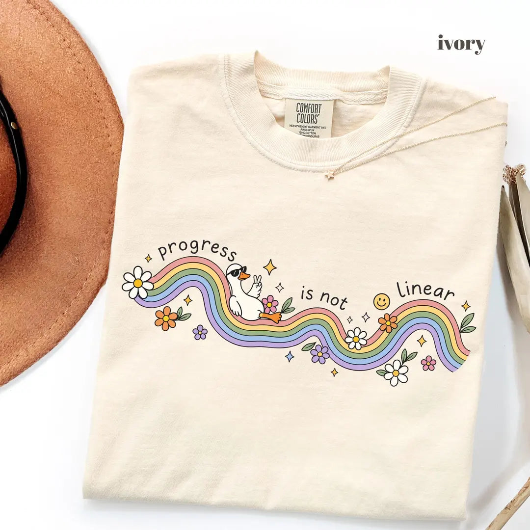 Ivory Comfort Colors 1717 T-shirt with Progress Is Not Linear design worn by a model