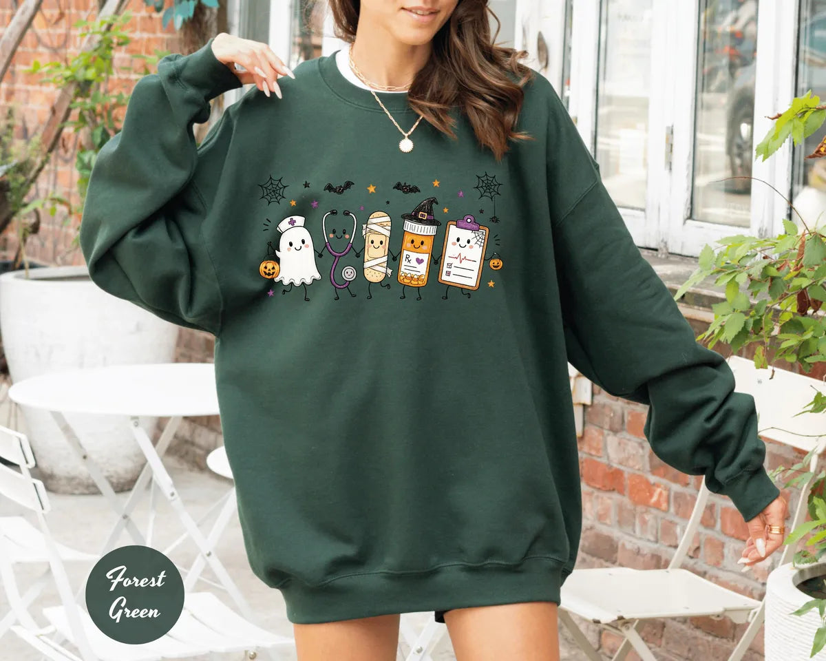 Forest Green crewneck sweatshirt with a ghost, stethoscope, bandage and medical chart characters with Halloween details, worn by a model.