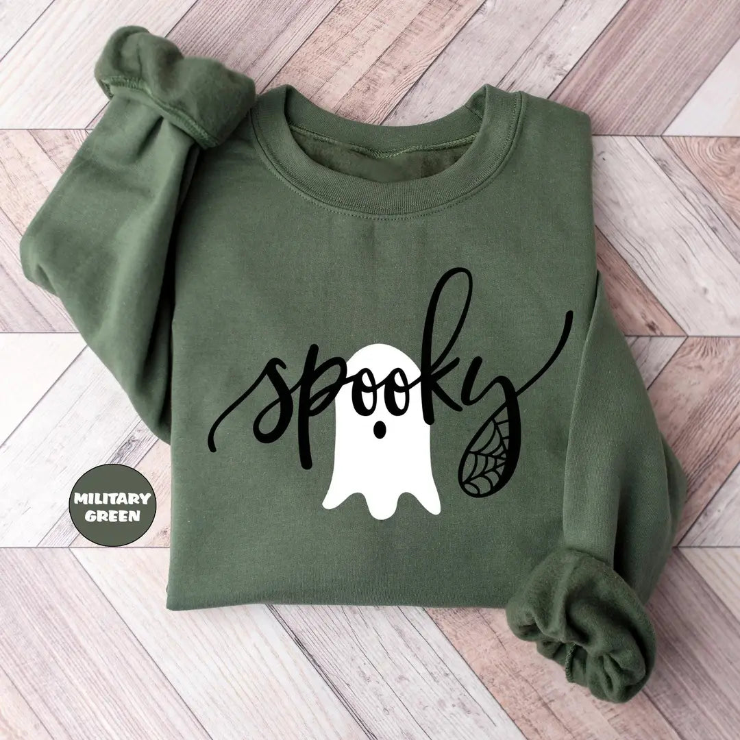 Military Green crewneck sweatshirt with the script word spooky with a ghost and spider web, flat lay view.