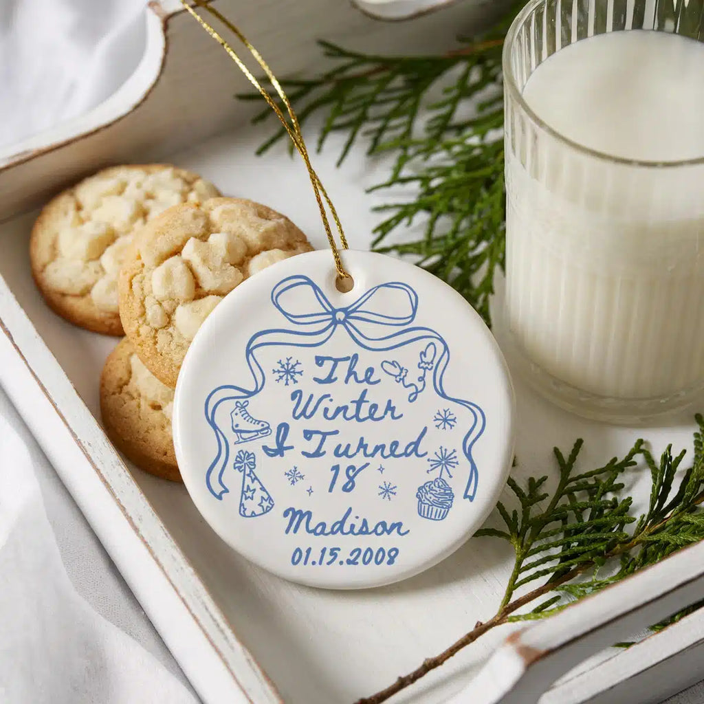Personalized ceramic ornament featuring Winter I Turned 18 shown in a cookies-and-milk lifestyle scene.