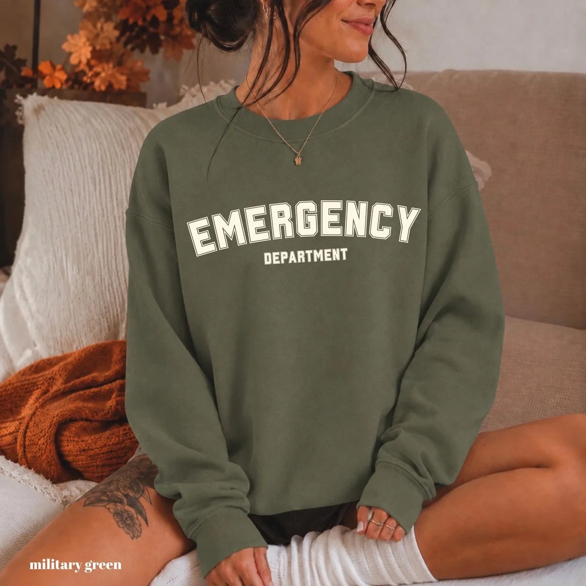 Military Green crewneck sweatshirt with printed varsity style emergency department lettering, worn by a model.