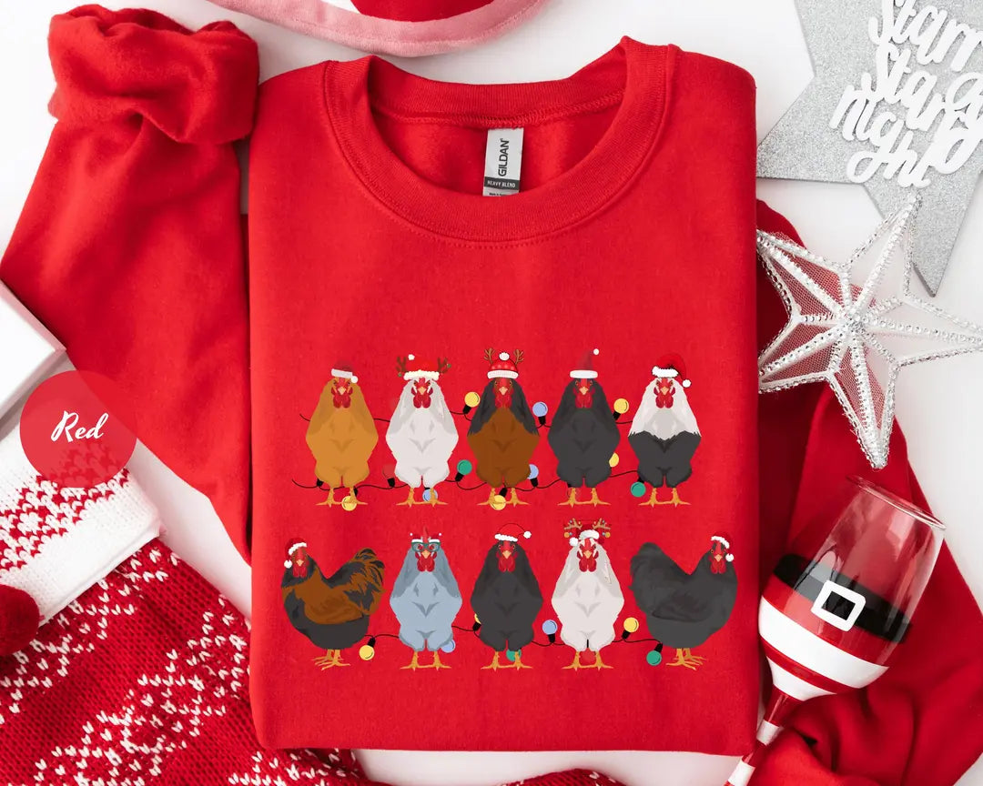Red GD crewneck sweatshirt with two rows of colorful chickens wearing Santa hats, flat lay view.