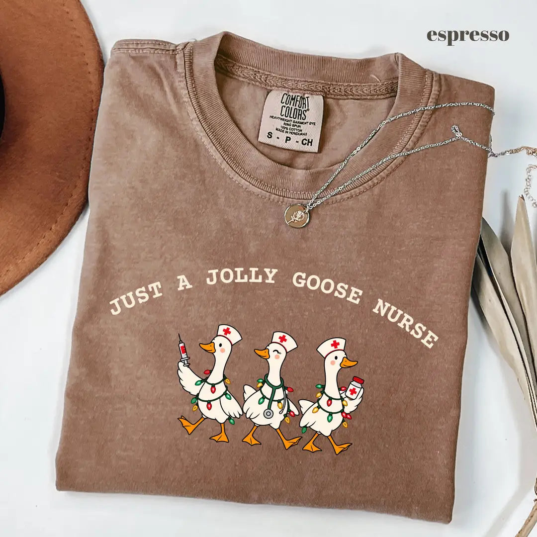 Espresso Comfort Colors 1717 T-shirt with Jolly Goose Christmas Nurse design worn by a model