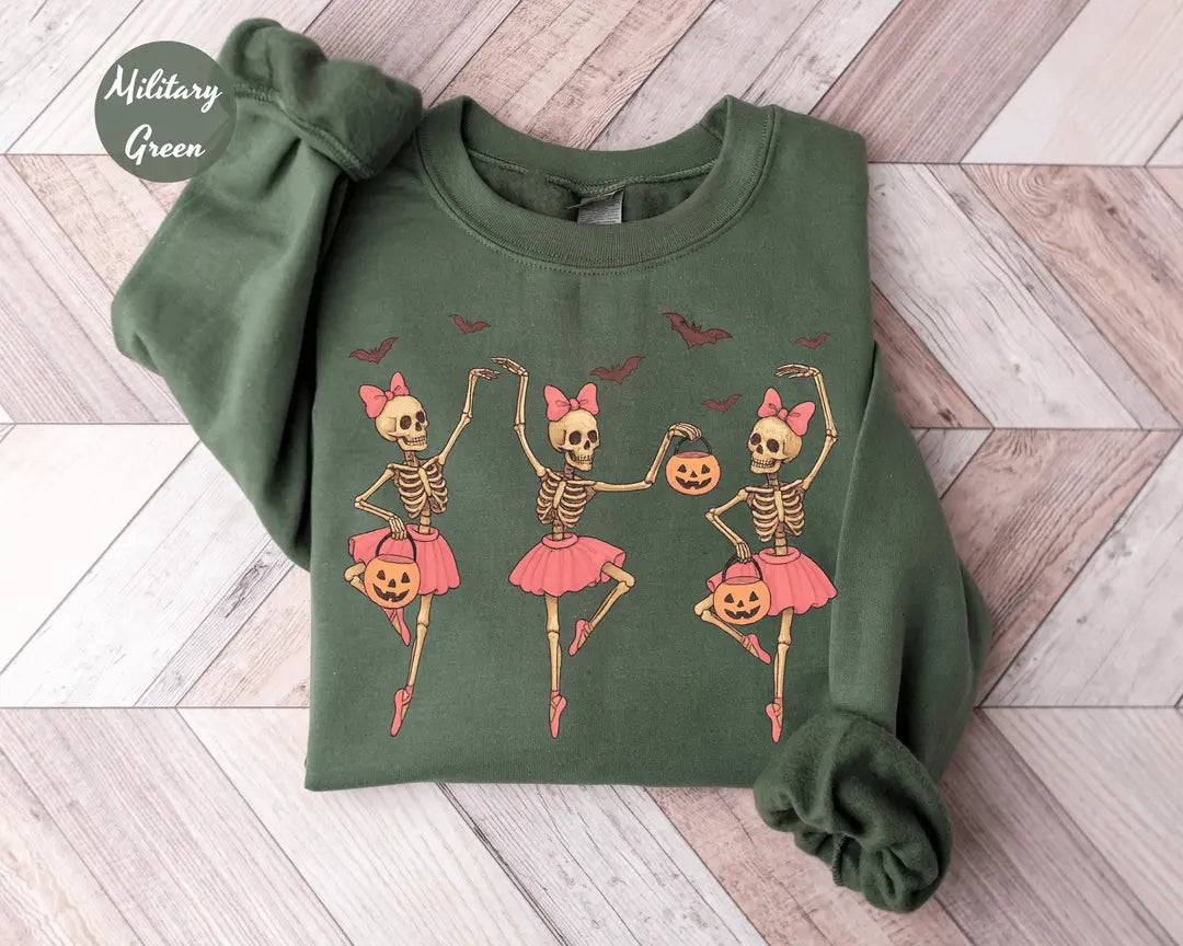 Military Green crewneck sweatshirt with printed three ballerina skeletons in pink tutus with pumpkins and bats, flat lay view.
