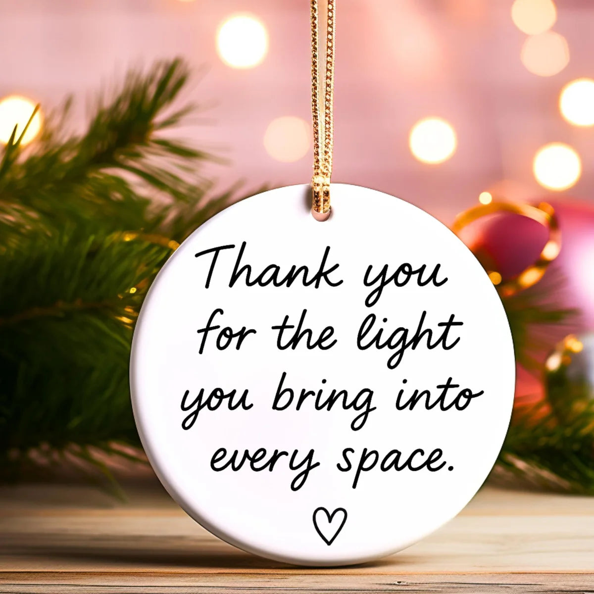 Alternate view of a round ceramic ornament with the visible Thank You for the Light You Bring message.