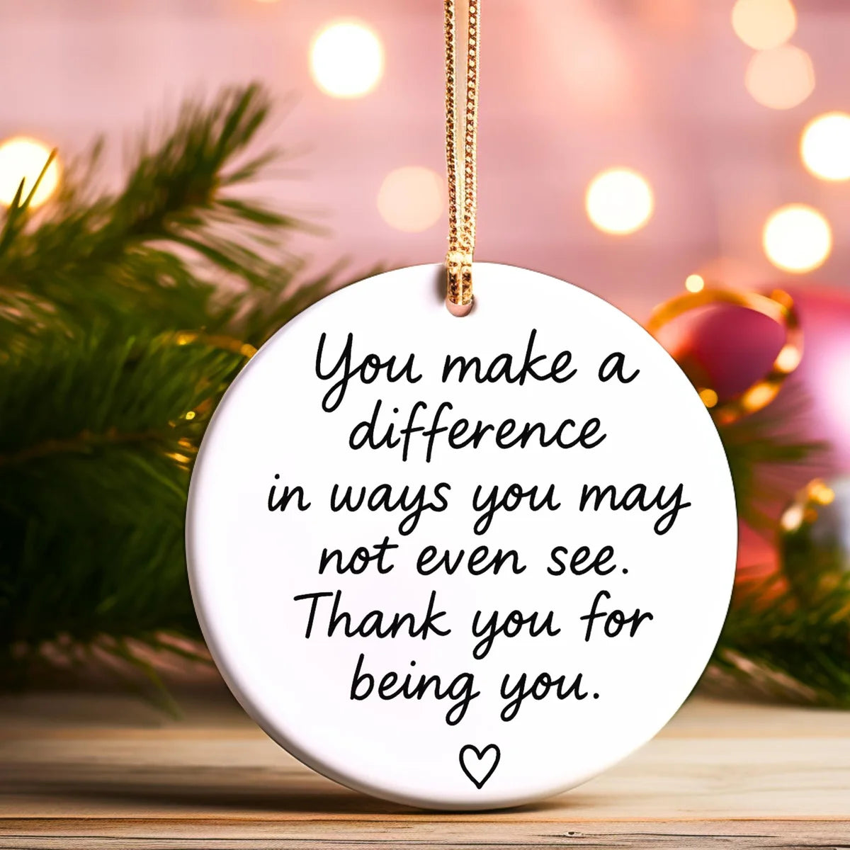 Alternate view of a round ceramic ornament with the visible You Make a Difference message.
