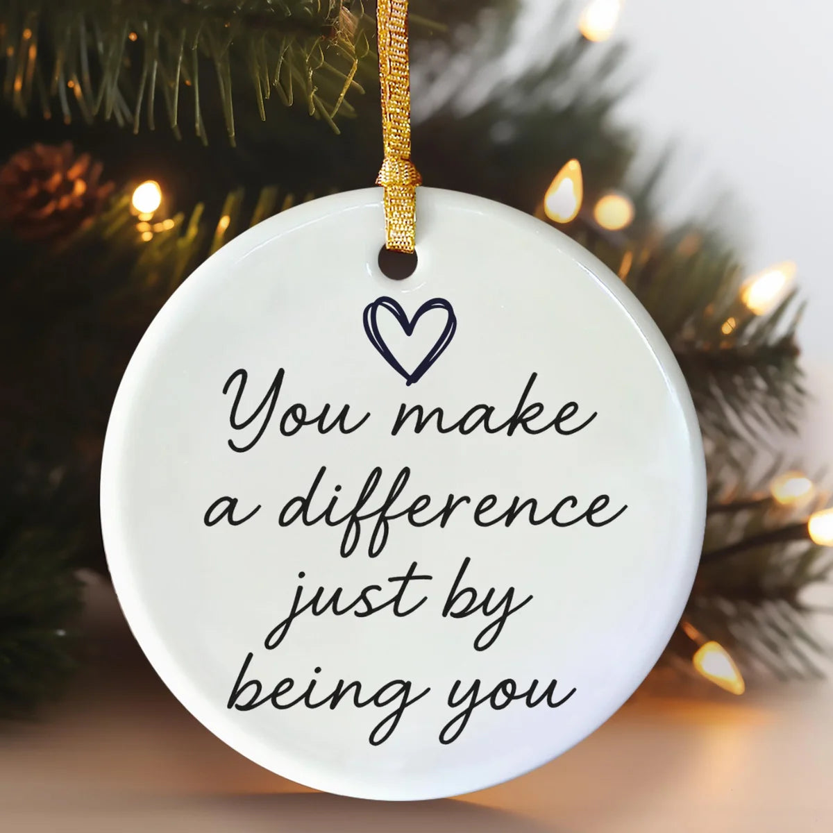 Alternate view of a round ceramic ornament with the visible You Make Every Day a Little Brighter message.