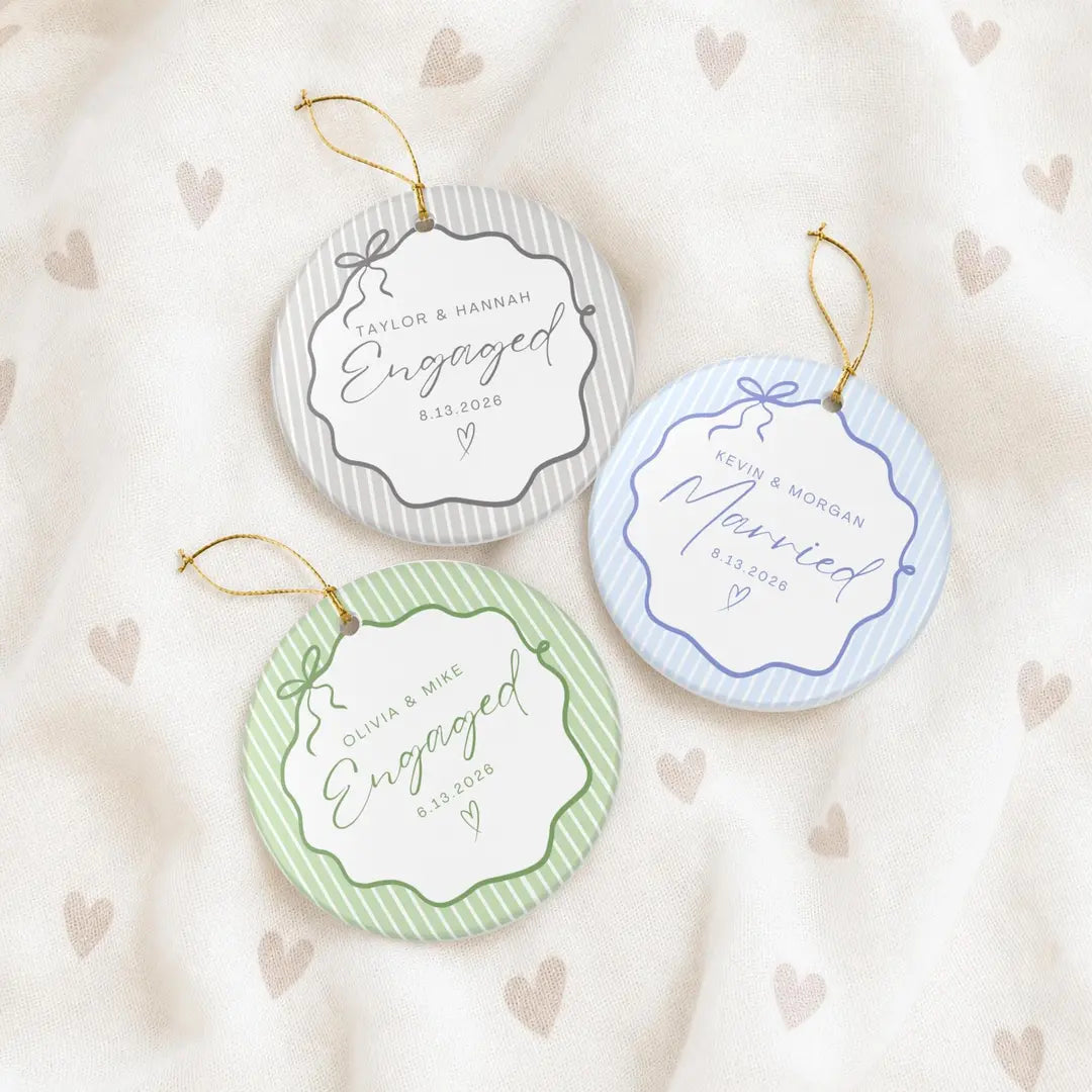 Gray and green Engaged and light blue Married pinstripe round ceramic ornaments with personalized names and date on a heart-print fabric
