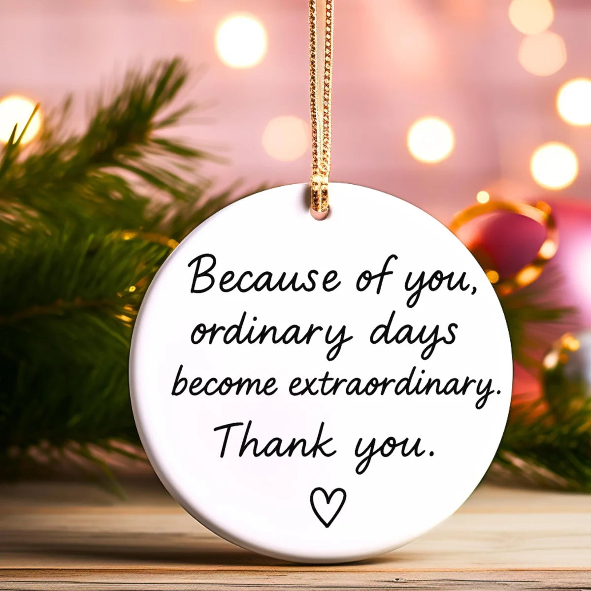 Alternate view of a round ceramic ornament with the visible Because of You message.