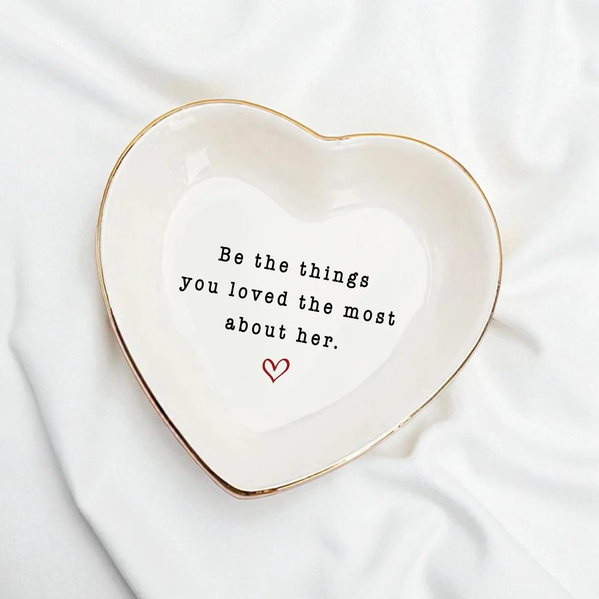 Heart-shaped ceramic memorial ring dish with gold rim and the quote Be the things you loved the most about her