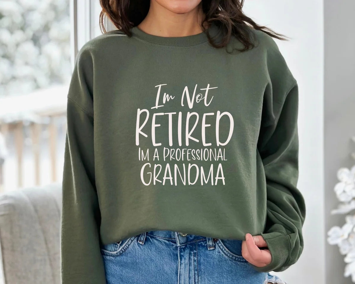 Crewneck sweatshirt with I'm Not Retired I'm A Professional Grandma design, alternate product view.