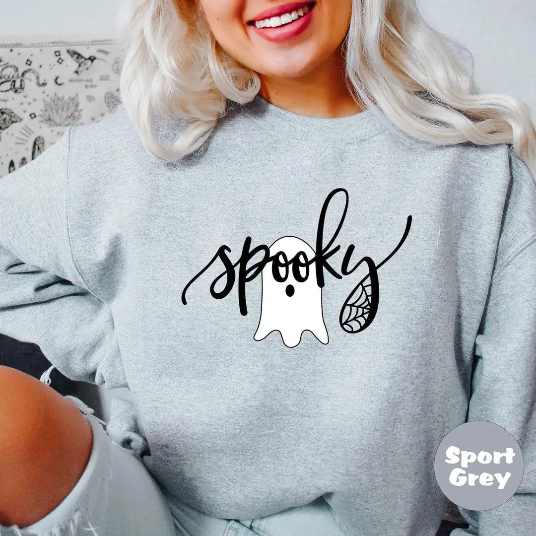 Sport Grey crewneck sweatshirt with the script word spooky with a ghost and spider web, worn by a model.