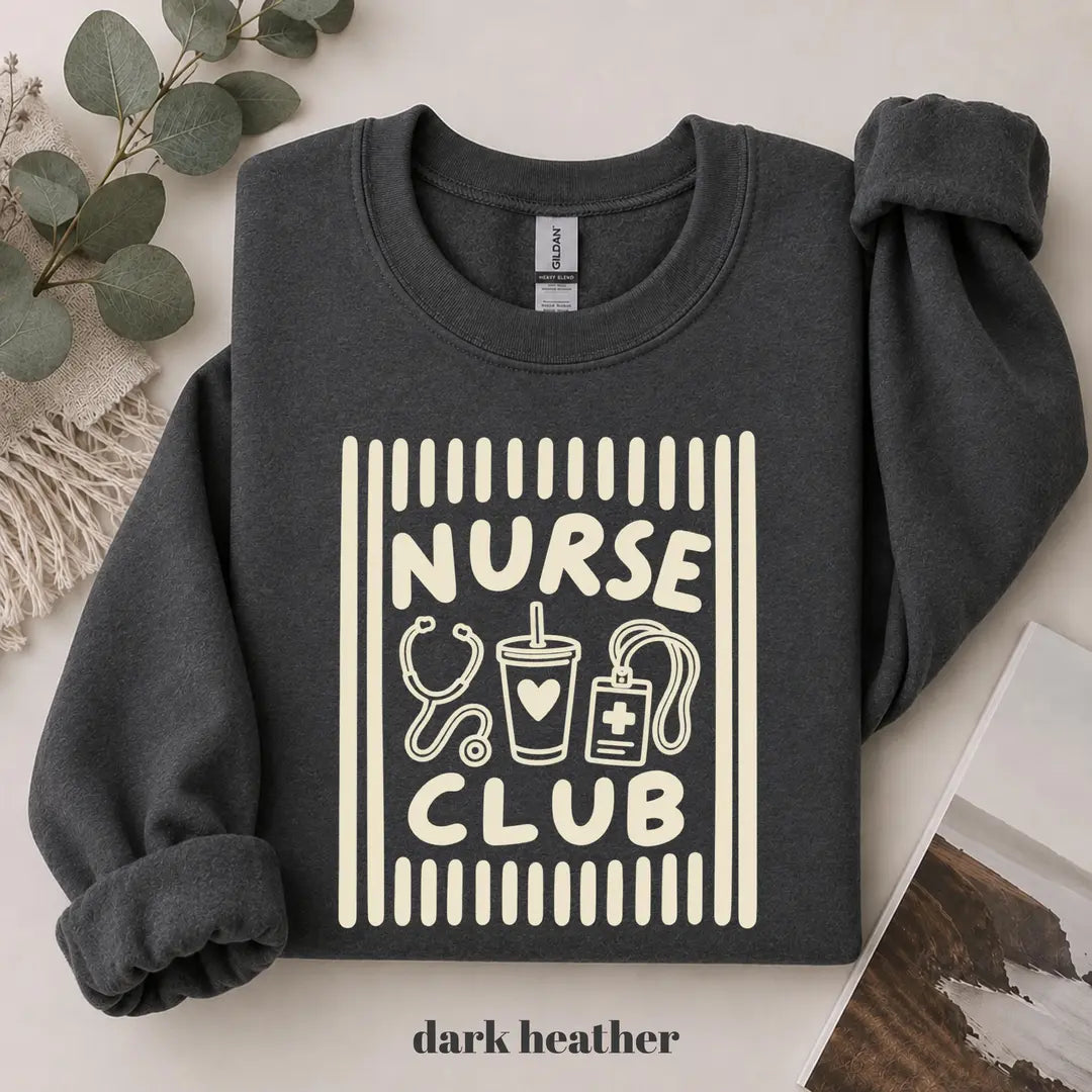Dark Heather crewneck sweatshirt with printed a retro striped frame with a stethoscope, coffee cup and badge above the words nurse club, flat lay view.