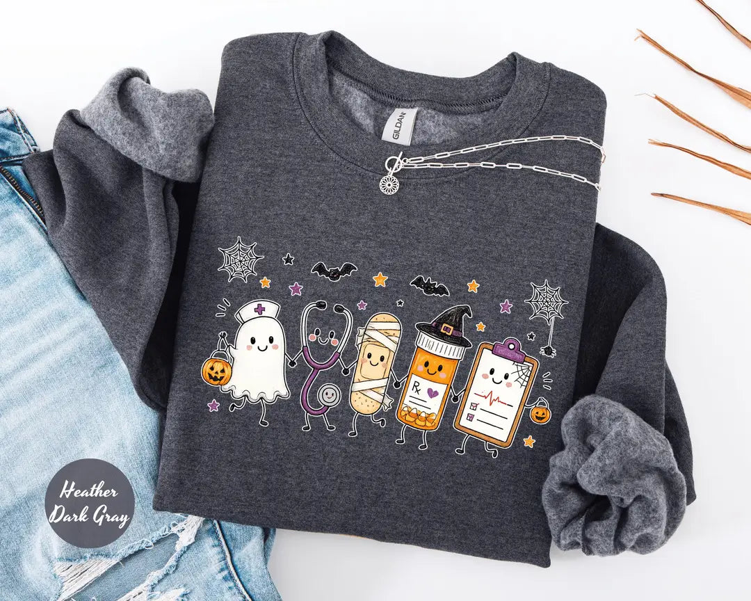 Heather Dark Gray crewneck sweatshirt with a ghost, stethoscope, bandage and medical chart characters with Halloween details, flat lay view.