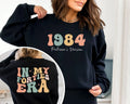 Black Crewneck sweatshirt with printed Custom In My Forties Era design, hero view.