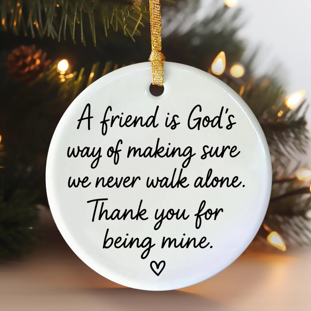Alternate view of a round ceramic ornament with the visible A Friend Is God's Way message.