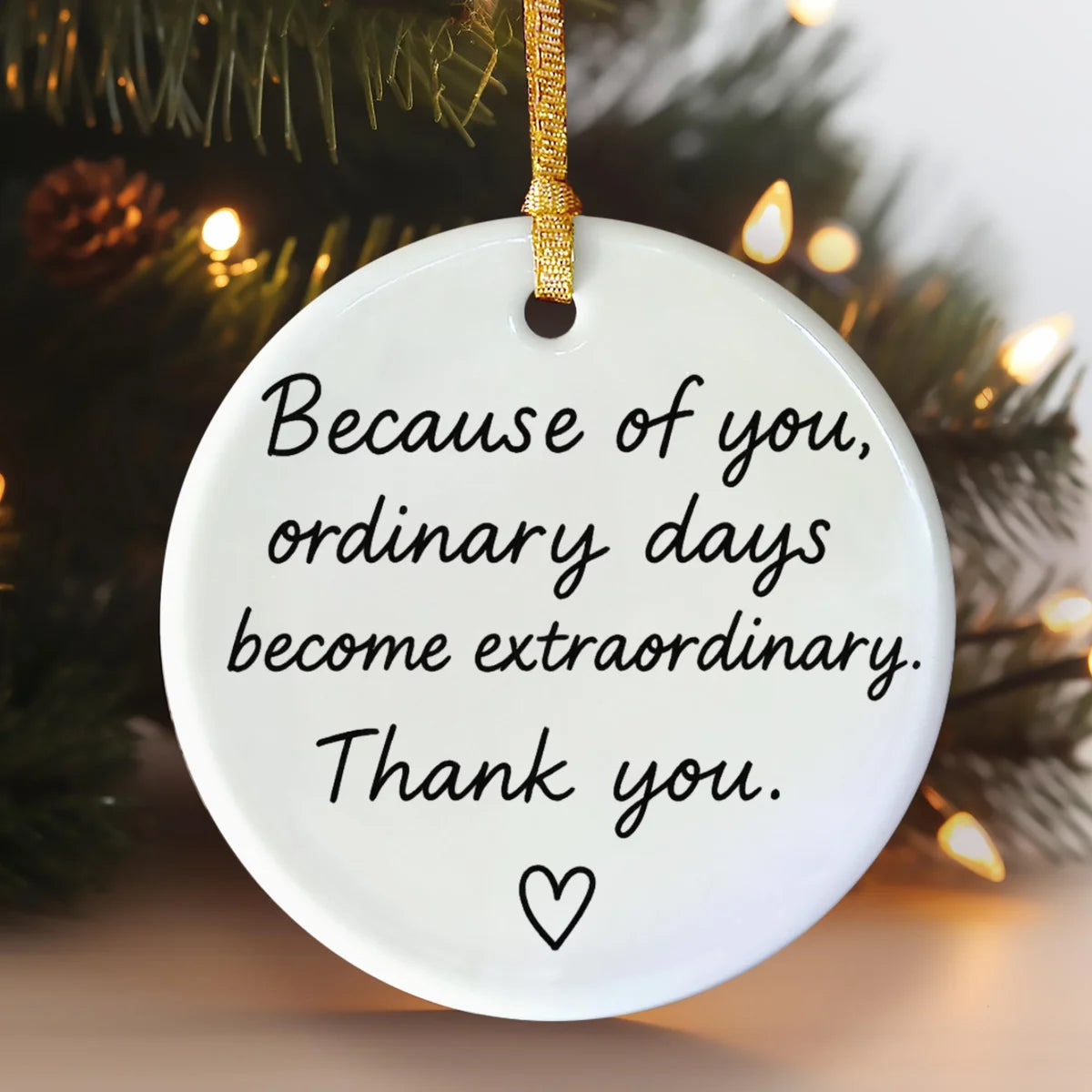 Alternate view of a round ceramic ornament with the visible Because of You message.