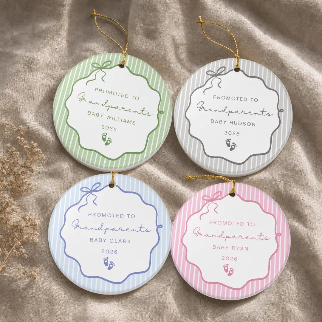 Four round white ceramic Promoted to Grandparents ornaments with pinstripe bow frames in green, gray, blue, and pink, baby footprints, and a personalized name and year