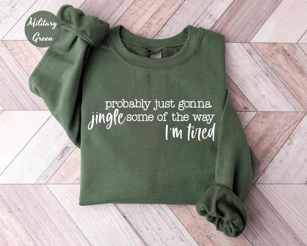 Military Green crewneck sweatshirt with script lettering that reads probably just gonna jingle some of the way I'm tired, flat lay view.