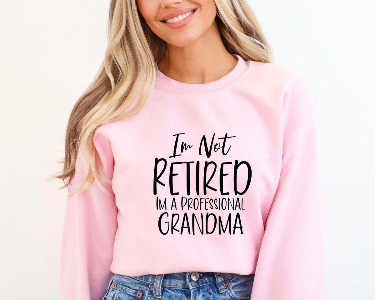 White Crewneck sweatshirt with I'm Not Retired I'm A Professional Grandma design, alternate product view.