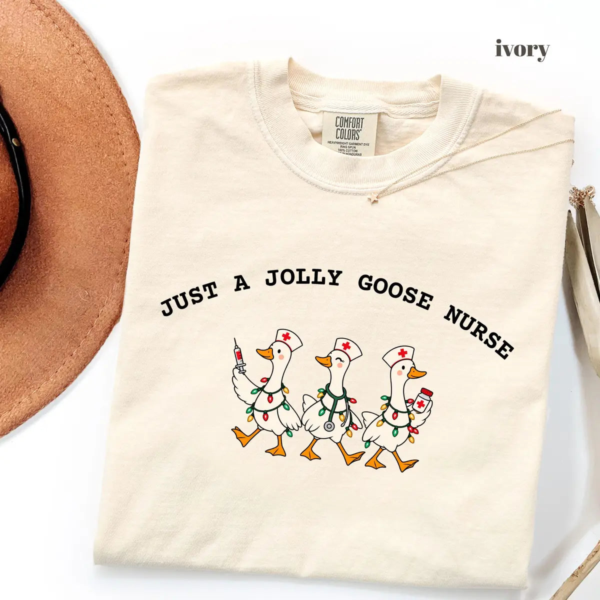 Ivory Comfort Colors 1717 T-shirt with Jolly Goose Christmas Nurse design worn by a model