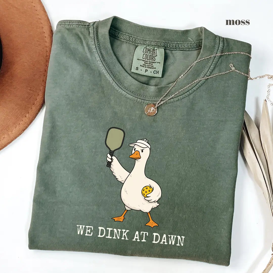 Moss Comfort Colors 1717 T-shirt with We Dink At Dawn design worn by a model view 2