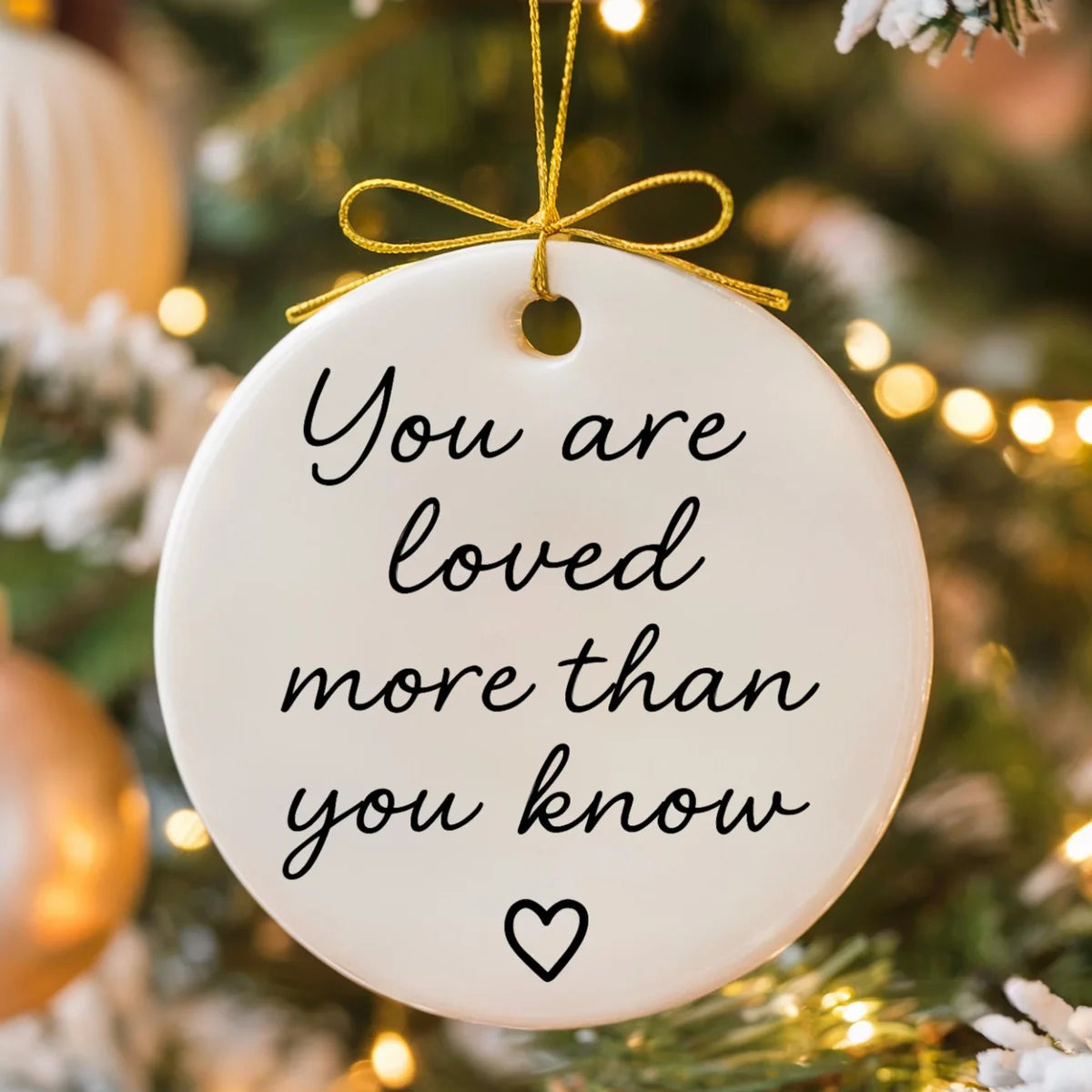 Alternate view of a round ceramic ornament with the visible You Are Loved More Than You Know message.