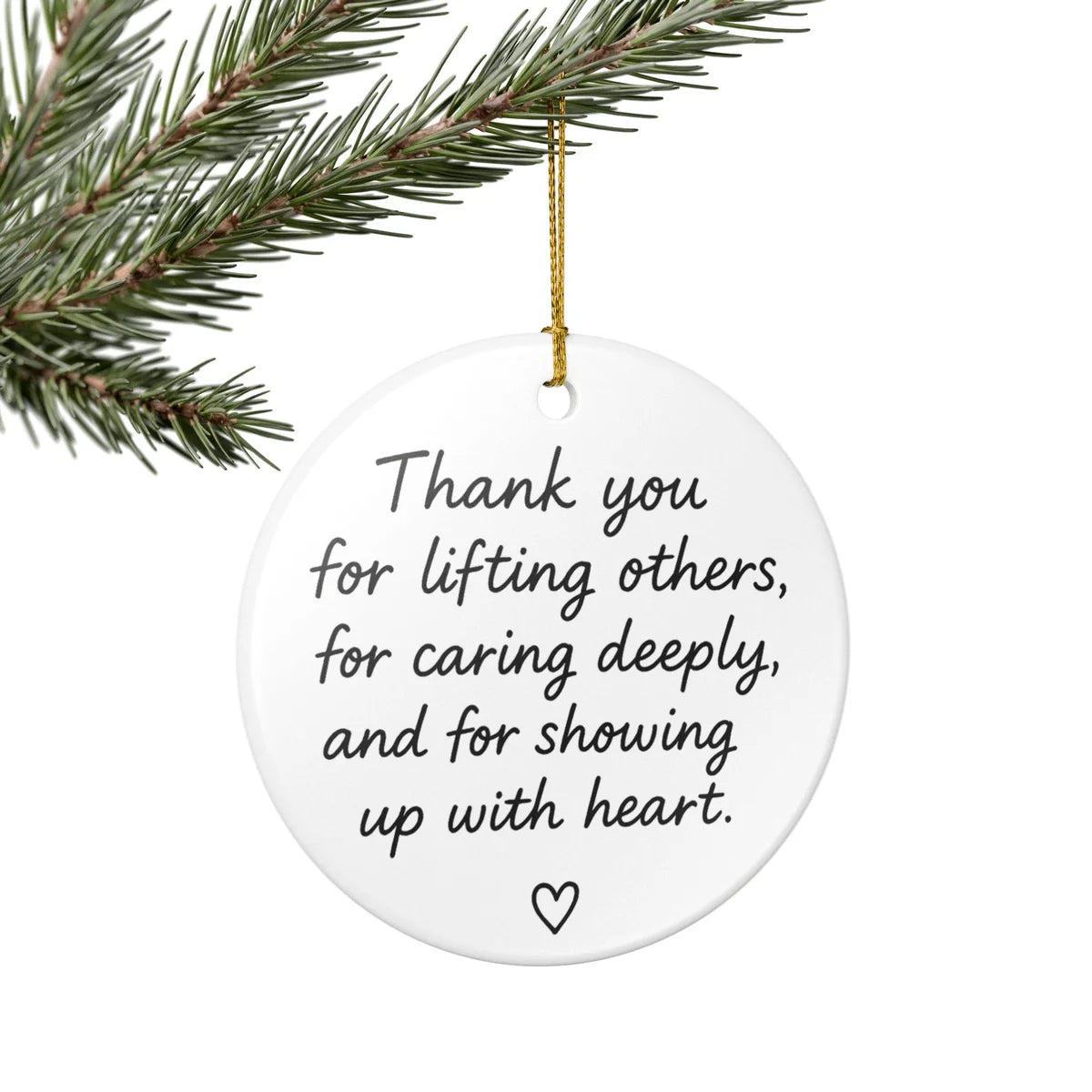 Alternate view of a round ceramic ornament with the visible Showing Up With Heart message.
