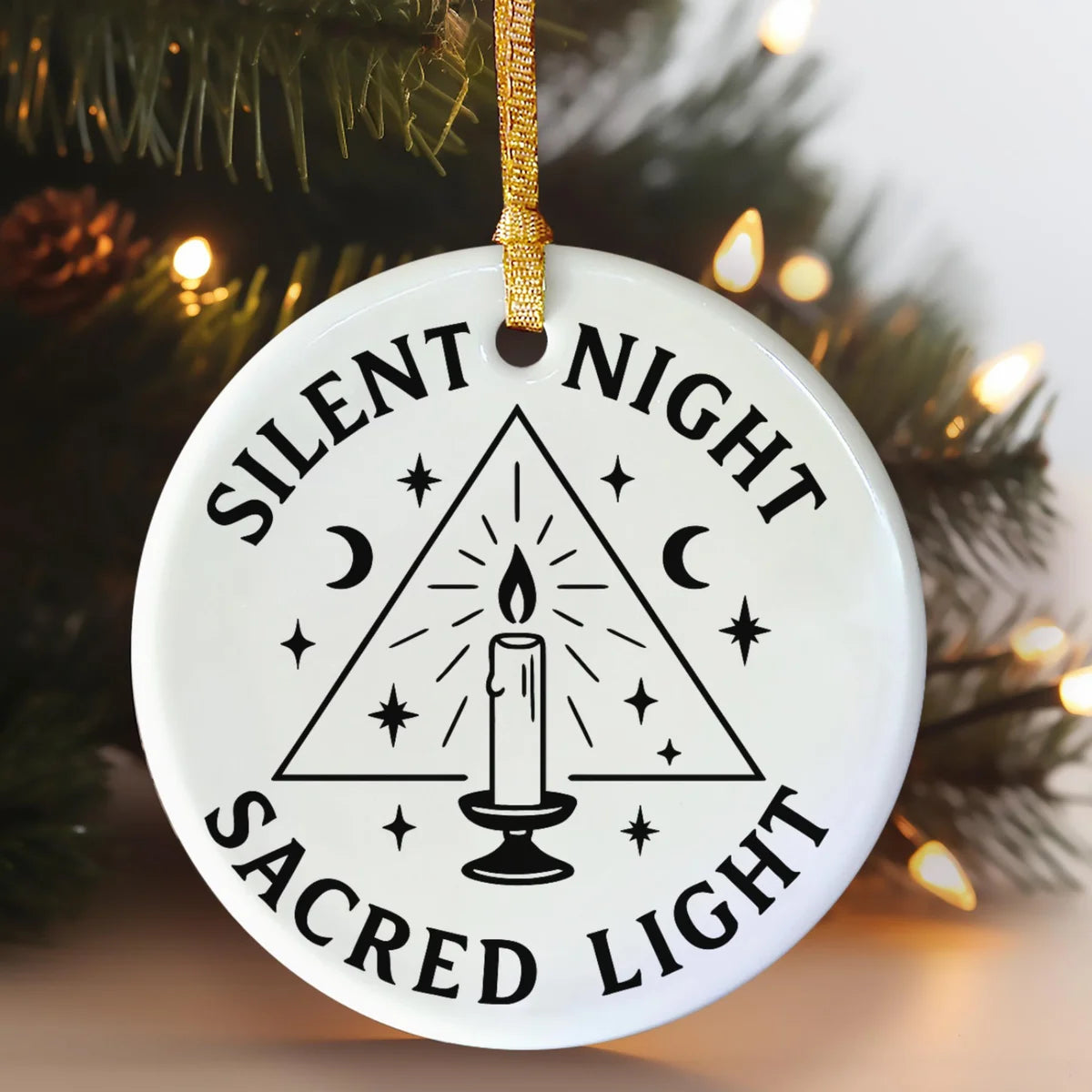 Alternate view of a round ceramic ornament with the visible Silent Night Sacred Light message.