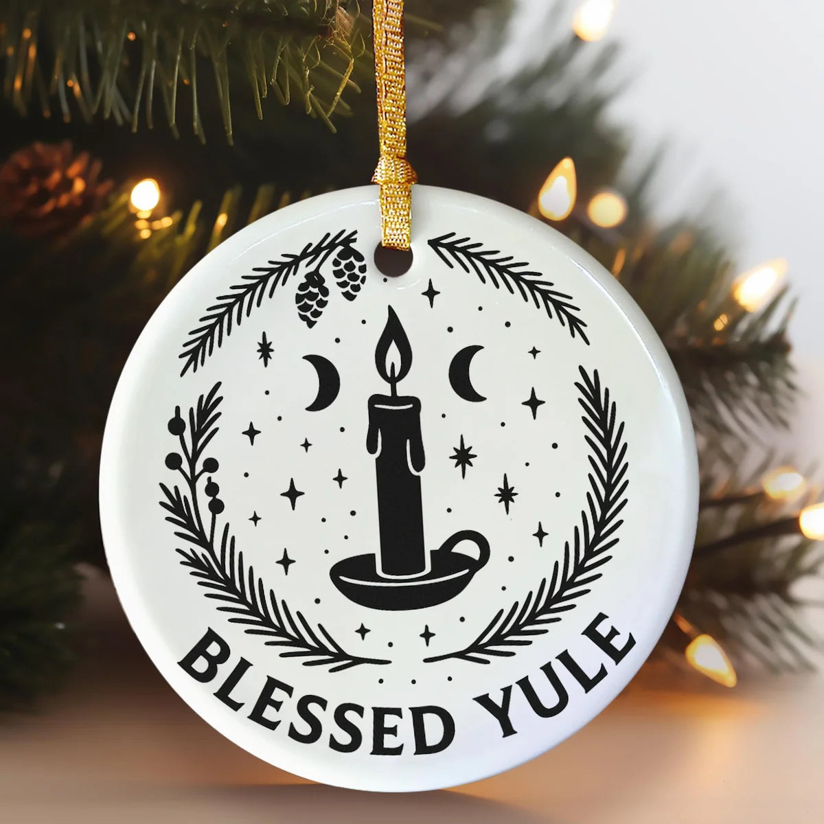 Alternate view of a round ceramic ornament with the visible Blessed Yule message.