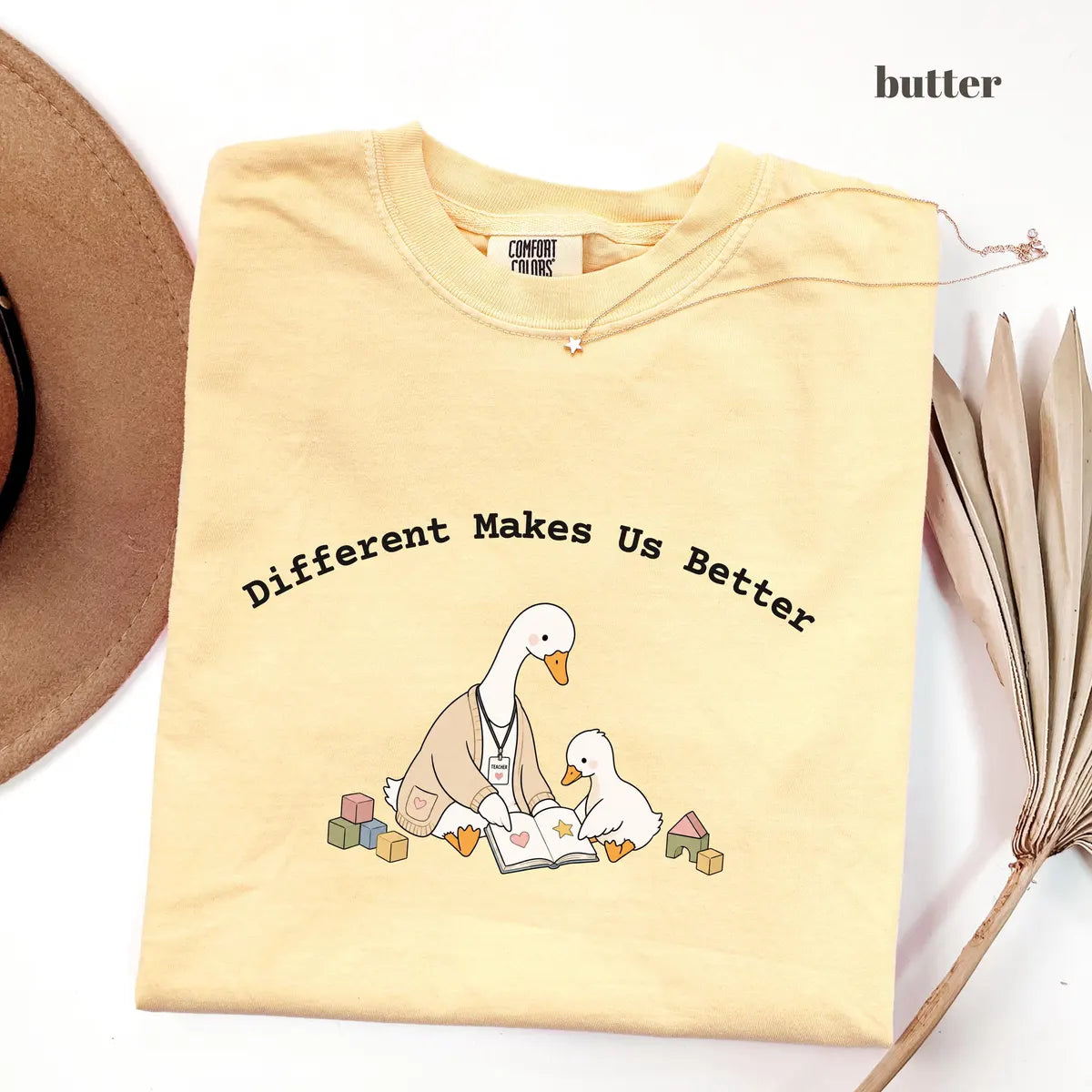 Butter Comfort Colors 1717 T-shirt with Different Makes Us Better design worn by a model