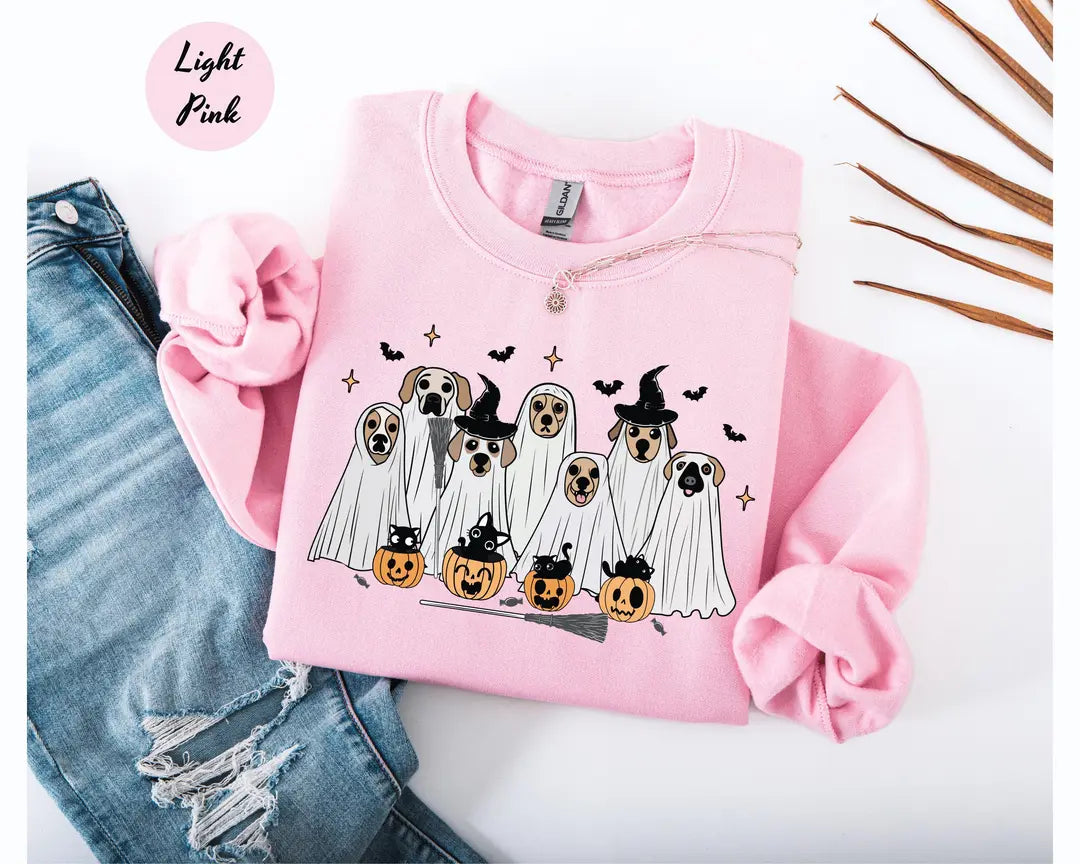 Light Pink crewneck sweatshirt with printed ghost dogs with witch hats, pumpkins and bats, flat lay view.