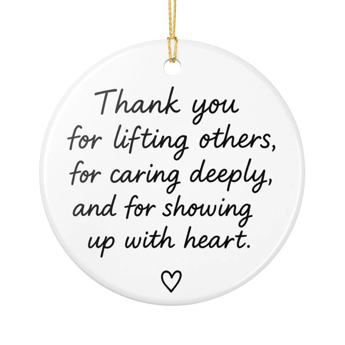 Alternate view of a round ceramic ornament with the visible Showing Up With Heart message.