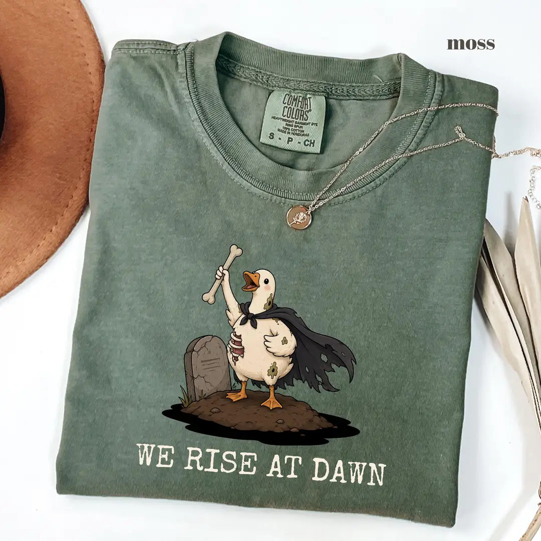 Moss Comfort Colors 1717 T-shirt with We Rise at Dawn Halloween design worn by a model