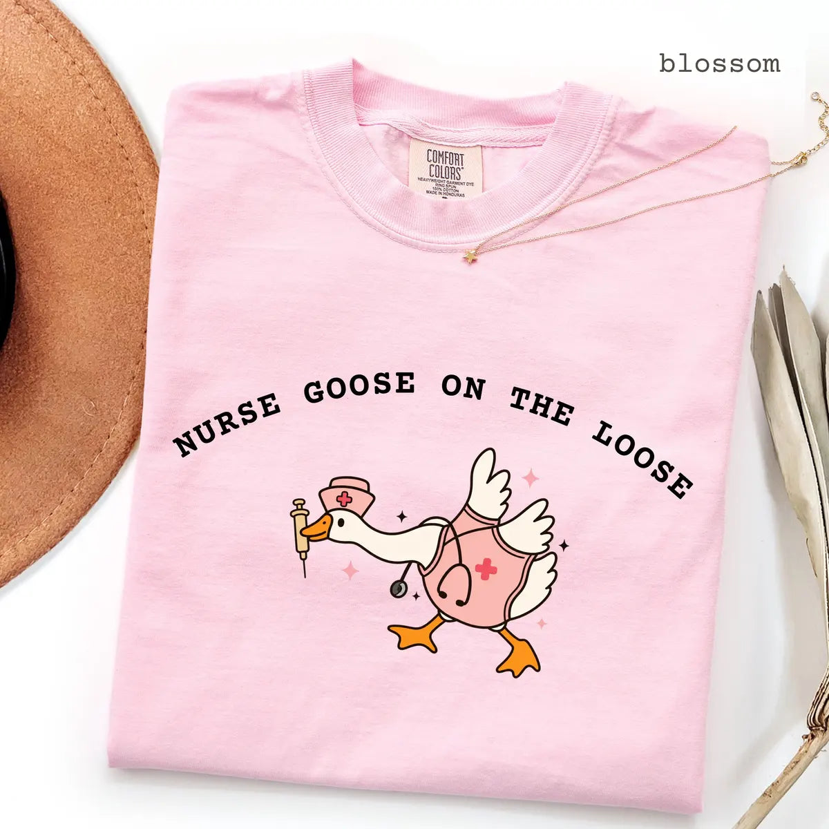 Blossom Comfort Colors 1717 T-shirt with Nurse Goose on the Loose design worn by a model