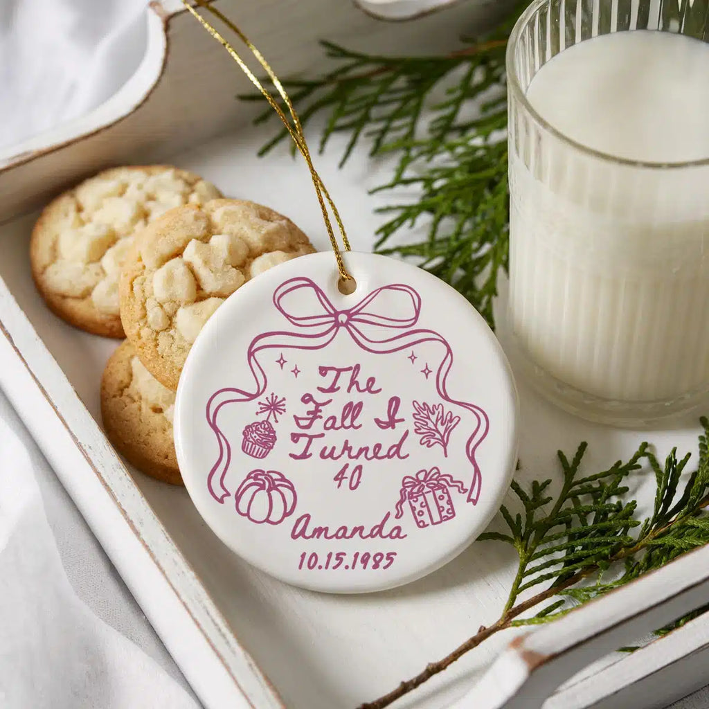Personalized The Fall I Turned 40 ceramic ornament shown in a cookies-and-milk lifestyle scene.