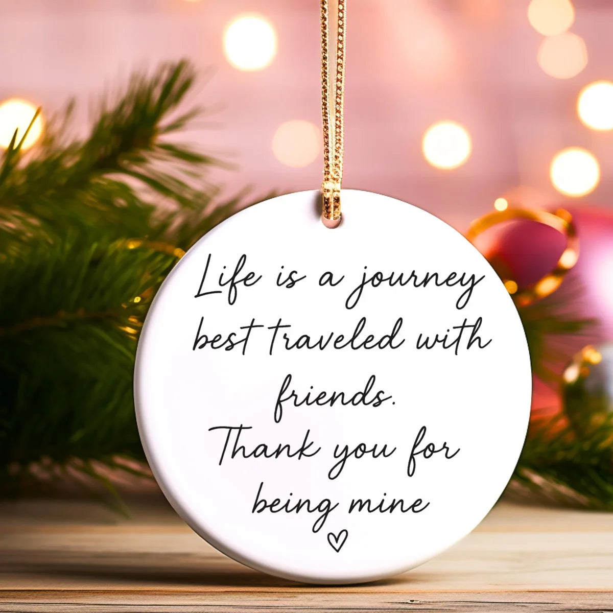 Alternate view of a round ceramic ornament with the visible Life Is a Journey Best Traveled With Friends message.