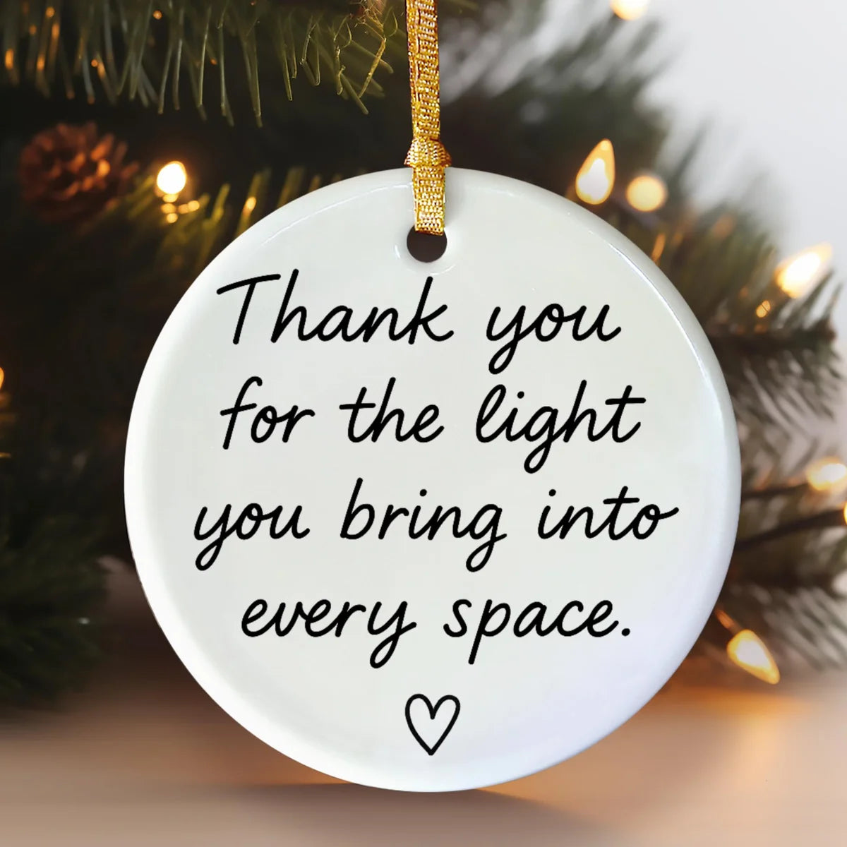 Alternate view of a round ceramic ornament with the visible Thank You for the Light You Bring message.