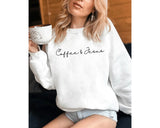 White crewneck sweatshirt with minimal script lettering that reads coffee & Jesus, worn by a model.