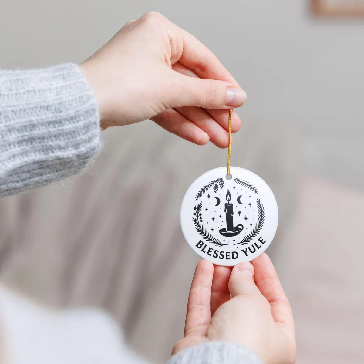 Alternate view of a round ceramic ornament with the visible Blessed Yule message.