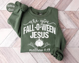 Military Green crewneck sweatshirt with printed a pumpkin with the words are you fall-o-ween jesus and matthew 4:19, flat lay view.
