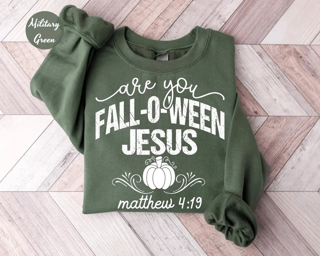 Military Green crewneck sweatshirt with printed a pumpkin with the words are you fall-o-ween jesus and matthew 4:19, flat lay view.