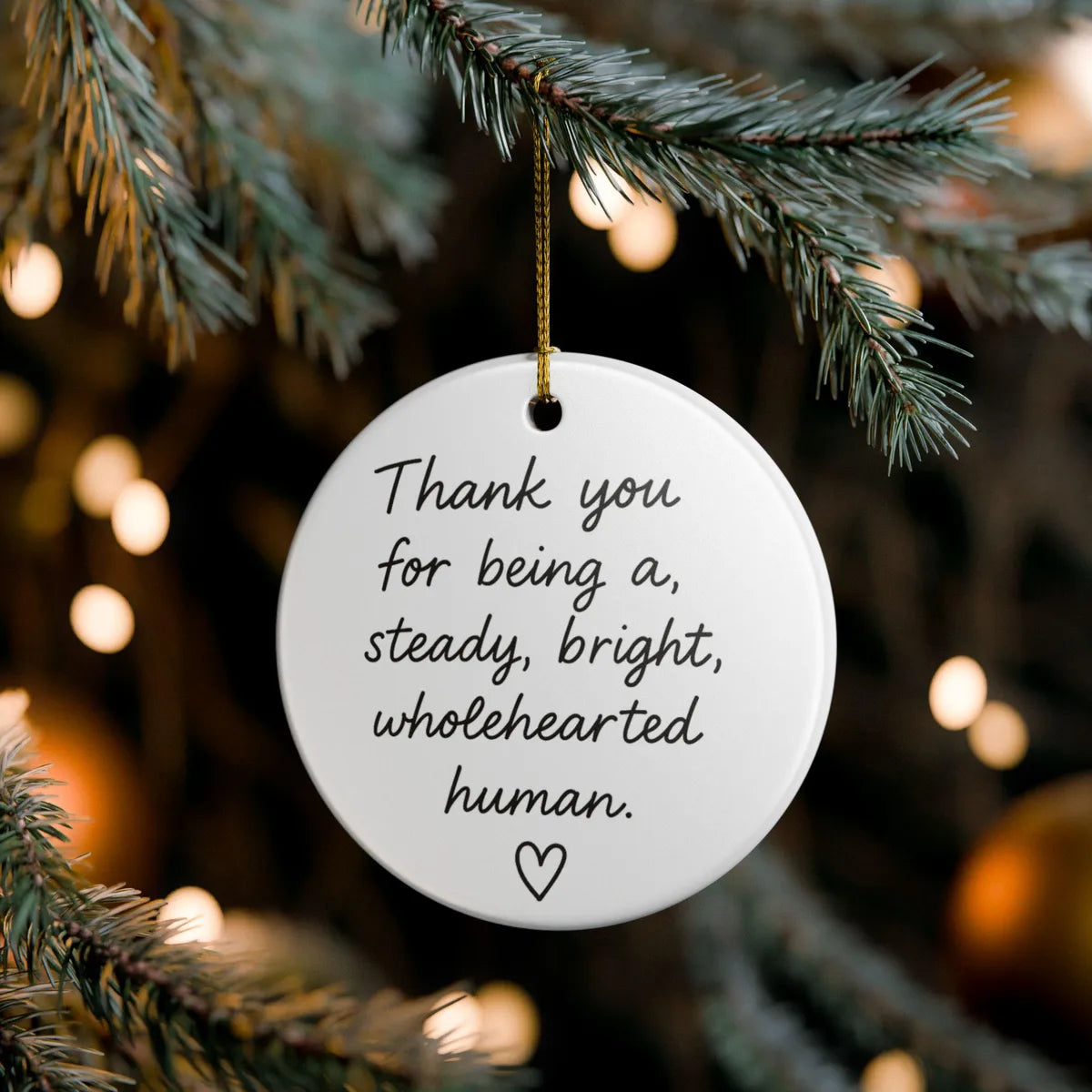 Alternate view of a round ceramic ornament with the visible Steady Bright Wholehearted message.